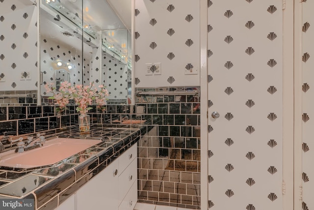 7900 Ivy Ln, Baltimore, MD 21208 - bathroom with wallpapered walls, vanity, and tile walls