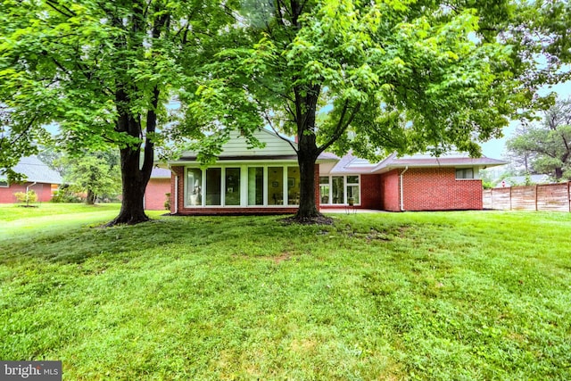 7900 Ivy Ln, Baltimore, MD 21208 - rear view of house featuring brick siding and a sunroom