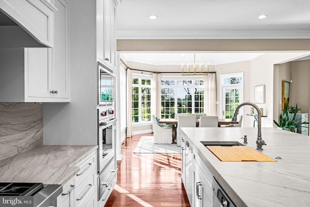 3537 Sawmill Rd, Newtown Square, PA 19073 - kitchen with appliances with stainless steel finishes, wood finished floors, recessed lighting, a chandelier, and white cabinets