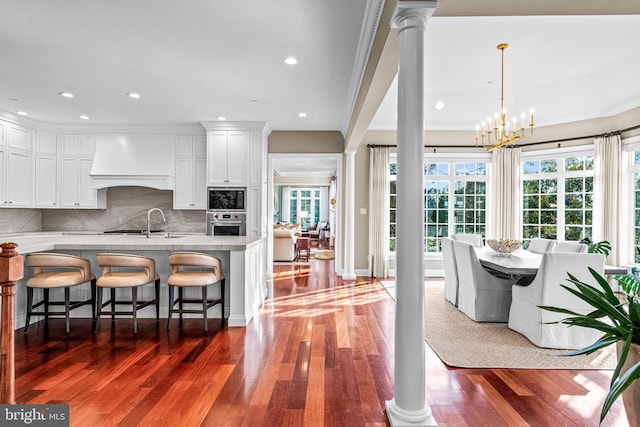 3537 Sawmill Rd, Newtown Square, PA 19073 - kitchen with custom range hood, appliances with stainless steel finishes, healthy amount of natural light, ornate columns, and recessed lighting