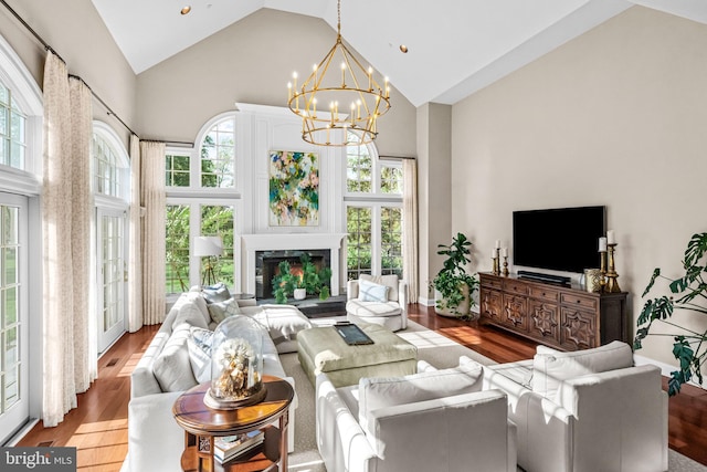 3537 Sawmill Rd, Newtown Square, PA 19073 - living area with high vaulted ceiling, wood finished floors, plenty of natural light, a chandelier, and a fireplace with raised hearth