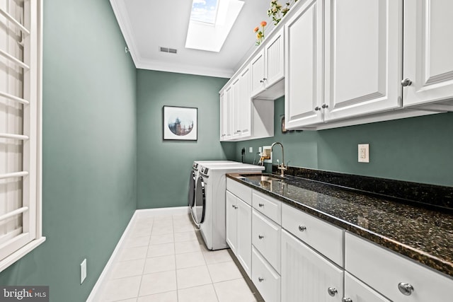 3537 Sawmill Rd, Newtown Square, PA 19073 - washroom featuring a skylight, separate washer and dryer, cabinet space, crown molding, and light tile patterned floors