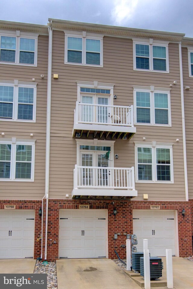 13764 Earhart Cir, Herndon, VA 20171 - view of front of house featuring brick siding, driveway, and an attached garage