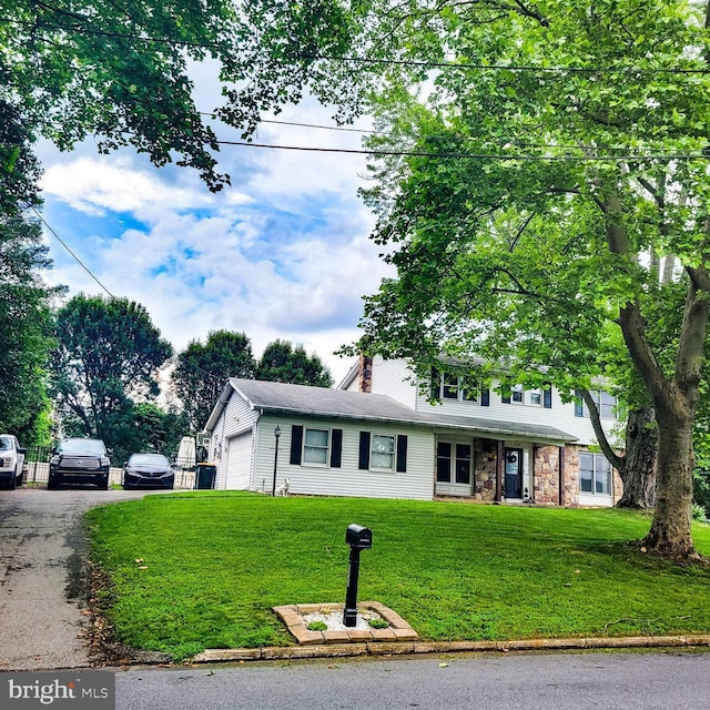 353 Wedgewood Dr, Easton, PA 18045 - view of front facade with an attached garage, a front lawn, and a chimney