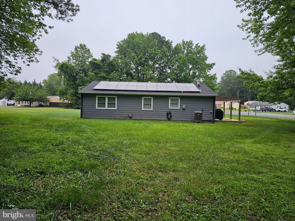 27133 Birch Manor Cir, Mechanicsville, MD 20659 - rear view of property with roof mounted solar panels and a lawn