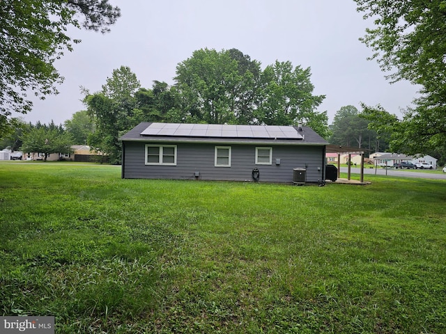 27133 Birch Manor Cir, Mechanicsville, MD 20659 - rear view of property with roof mounted solar panels and a lawn