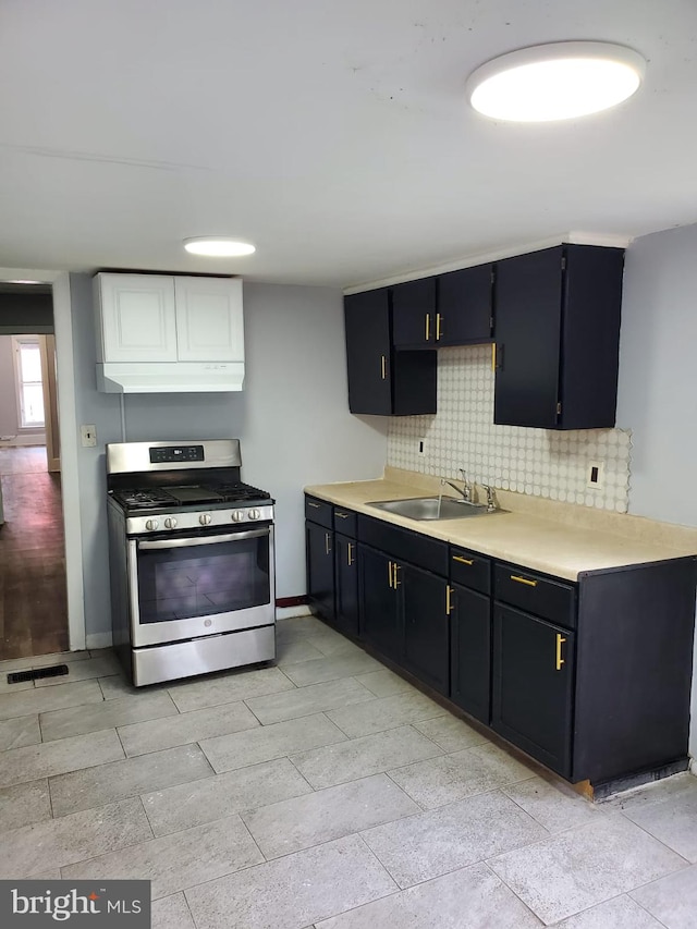 68 End, Trenton, NJ 08618 - kitchen with stainless steel range with gas stovetop, under cabinet range hood, tasteful backsplash, light countertops, and dark cabinets