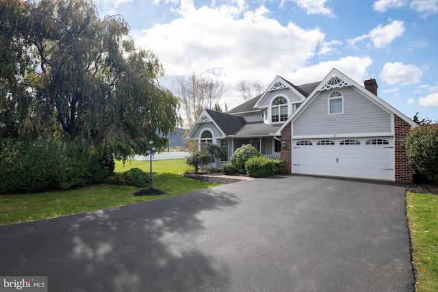 26 Sleigh Run, Reedsville, PA 17084 - view of front of home featuring driveway, a front lawn, a chimney, and brick siding