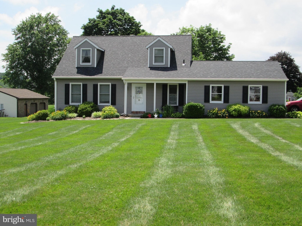 2515 Washington Dr, Gilbertsville, PA 19525 - cape cod house featuring a front yard and roof with shingles