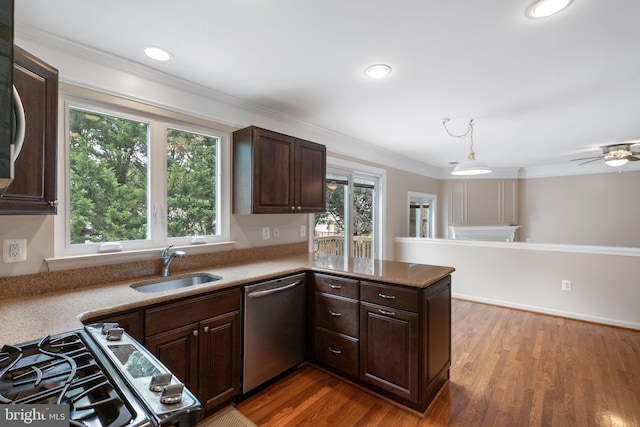 21411 Emerald Dr, Germantown, MD 20876 - kitchen with stainless steel appliances, dark brown cabinetry, ornamental molding, dark wood-style flooring, and a peninsula