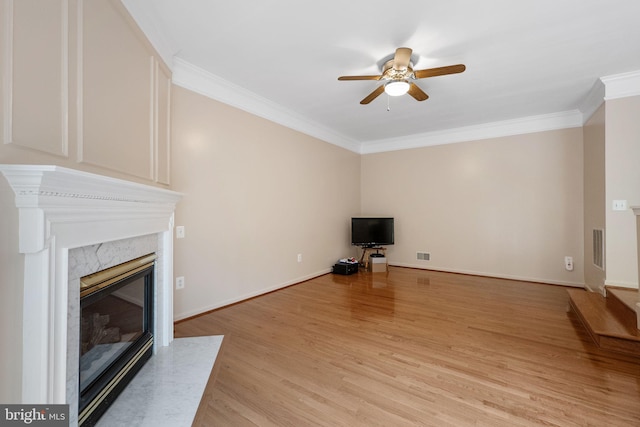 21411 Emerald Dr, Germantown, MD 20876 - unfurnished living room featuring a fireplace, ceiling fan, crown molding, and light wood-style floors