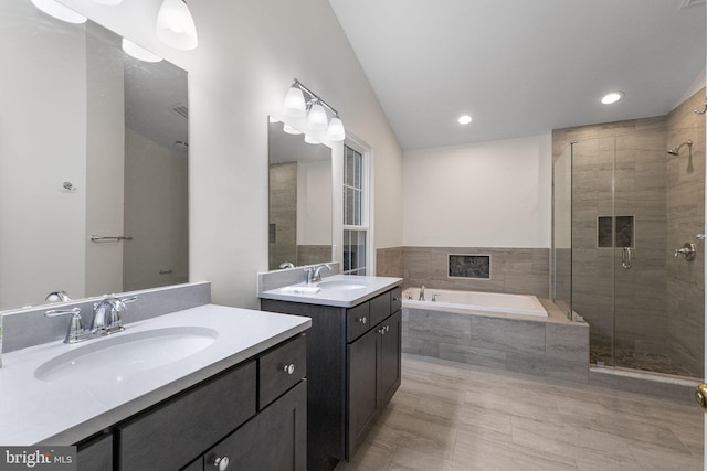 21411 Emerald Dr, Germantown, MD 20876 - bathroom with a shower stall, a bath, two vanities, and recessed lighting