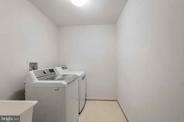 21411 Emerald Dr, Germantown, MD 20876 - laundry room featuring washer and dryer and light colored carpet