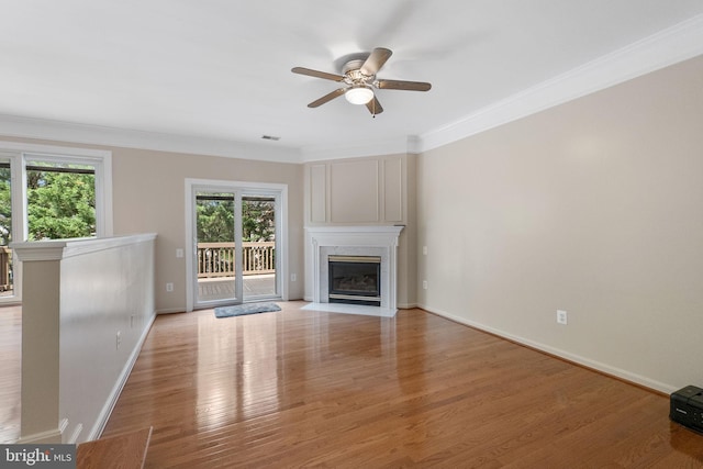 21411 Emerald Dr, Germantown, MD 20876 - unfurnished living room with a ceiling fan, a fireplace, ornamental molding, and light wood-type flooring