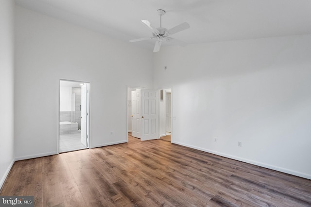 21411 Emerald Dr, Germantown, MD 20876 - unfurnished bedroom featuring high vaulted ceiling, wood finished floors, connected bathroom, and ceiling fan