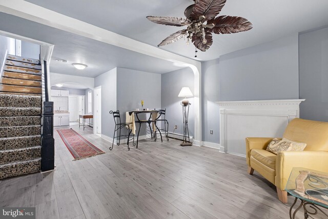 624 S Heald St, Wilmington, DE 19801 - sitting room with arched walkways, stairs, a ceiling fan, and wood finished floors