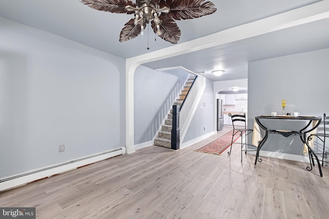 624 S Heald St, Wilmington, DE 19801 - dining room with arched walkways, a baseboard radiator, a ceiling fan, wood finished floors, and stairway