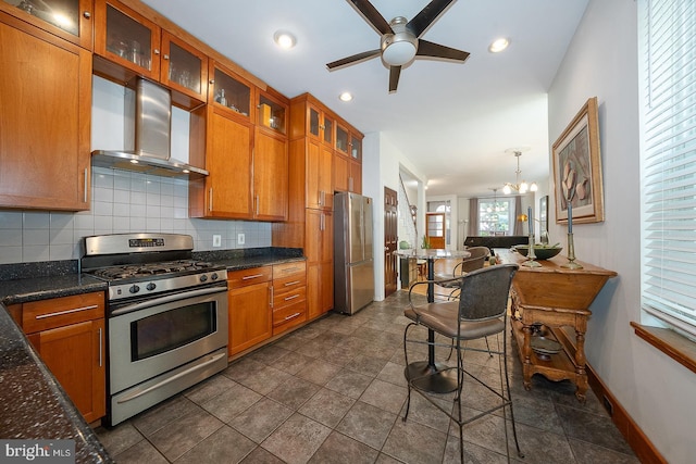 823 N 21st St, Philadelphia, PA 19130 - kitchen featuring stainless steel appliances, wall chimney exhaust hood, brown cabinetry, and recessed lighting