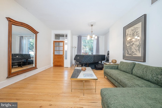 823 N 21st St, Philadelphia, PA 19130 - living area with light wood-style flooring, healthy amount of natural light, and a chandelier