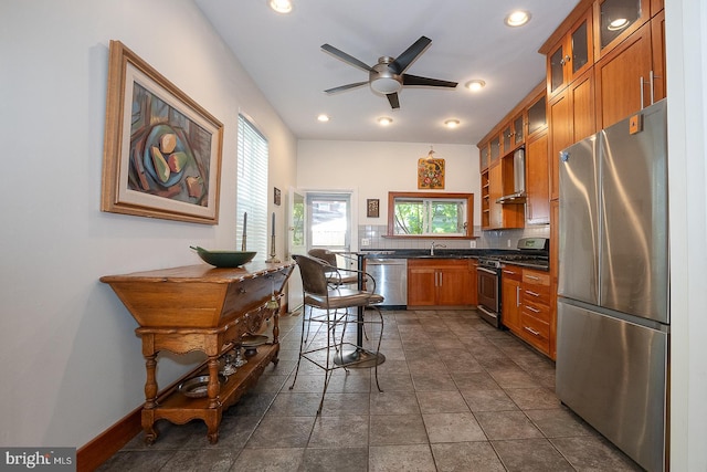 823 N 21st St, Philadelphia, PA 19130 - kitchen with stainless steel appliances, dark countertops, brown cabinetry, a ceiling fan, and recessed lighting