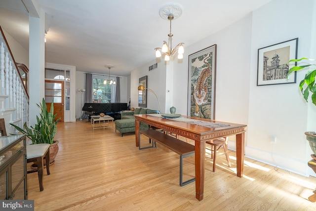 823 N 21st St, Philadelphia, PA 19130 - dining space with a chandelier, light wood-type flooring, and stairway