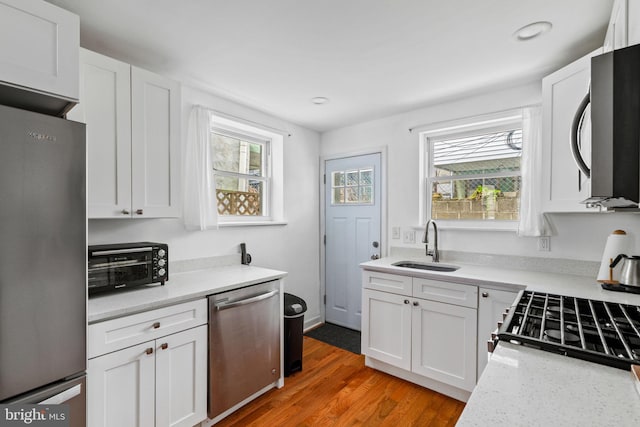 1645 S Carlisle St, Philadelphia, PA 19145 - kitchen with stainless steel appliances, healthy amount of natural light, white cabinetry, and recessed lighting