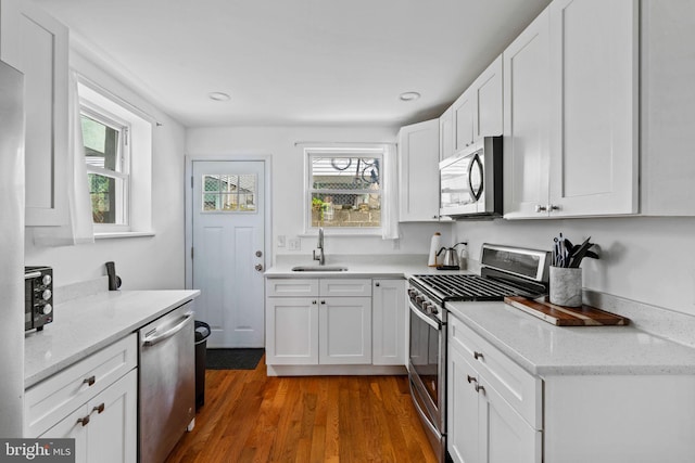 1645 S Carlisle St, Philadelphia, PA 19145 - kitchen with stainless steel appliances, plenty of natural light, white cabinetry, dark wood-style flooring, and recessed lighting