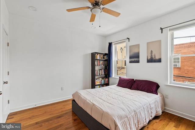 1645 S Carlisle St, Philadelphia, PA 19145 - bedroom featuring wood finished floors, multiple windows, and ceiling fan