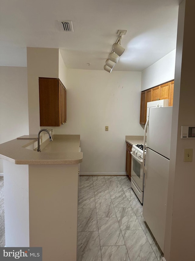 2204 Westcourt Ln Unit 313, Herndon, VA 20170 - kitchen featuring white appliances, light marble finish flooring, a peninsula, light countertops, and brown cabinets