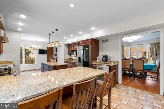 6212 Monroe Ave, Sykesville, MD 21784 - kitchen featuring stainless steel refrigerator with ice dispenser, a chandelier, decorative light fixtures, light stone countertops, and a peninsula