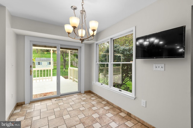 6212 Monroe Ave, Sykesville, MD 21784 - unfurnished dining area featuring a chandelier and baseboards