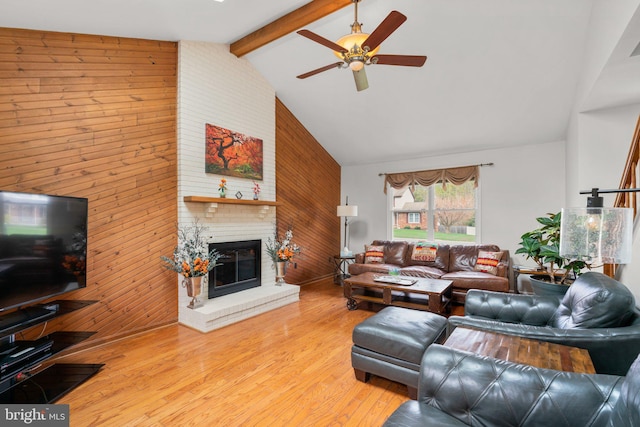 6212 Monroe Ave, Sykesville, MD 21784 - living room featuring wooden walls, a brick fireplace, ceiling fan, wood finished floors, and high vaulted ceiling