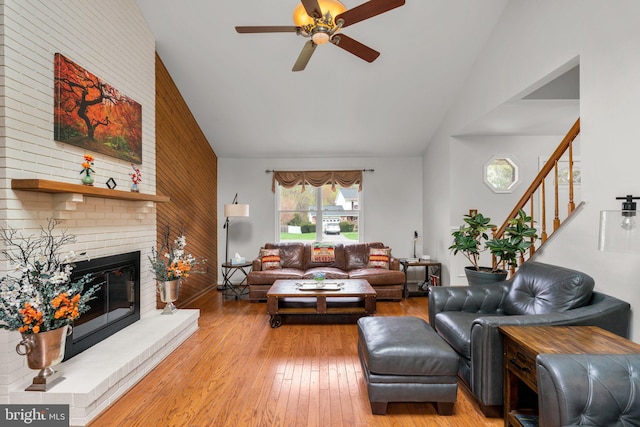 6212 Monroe Ave, Sykesville, MD 21784 - living area with lofted ceiling, a ceiling fan, light wood-style flooring, stairs, and a fireplace