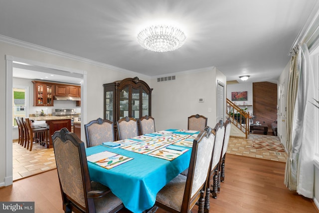 6212 Monroe Ave, Sykesville, MD 21784 - dining area with a chandelier, stairs, light wood finished floors, and crown molding