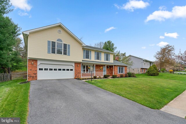 6212 Monroe Ave, Sykesville, MD 21784 - traditional-style home featuring covered porch, brick siding, driveway, and a garage