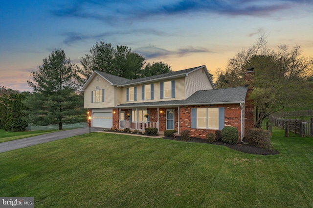 6212 Monroe Ave, Sykesville, MD 21784 - view of front of property with covered porch, a garage, driveway, a yard, and a chimney