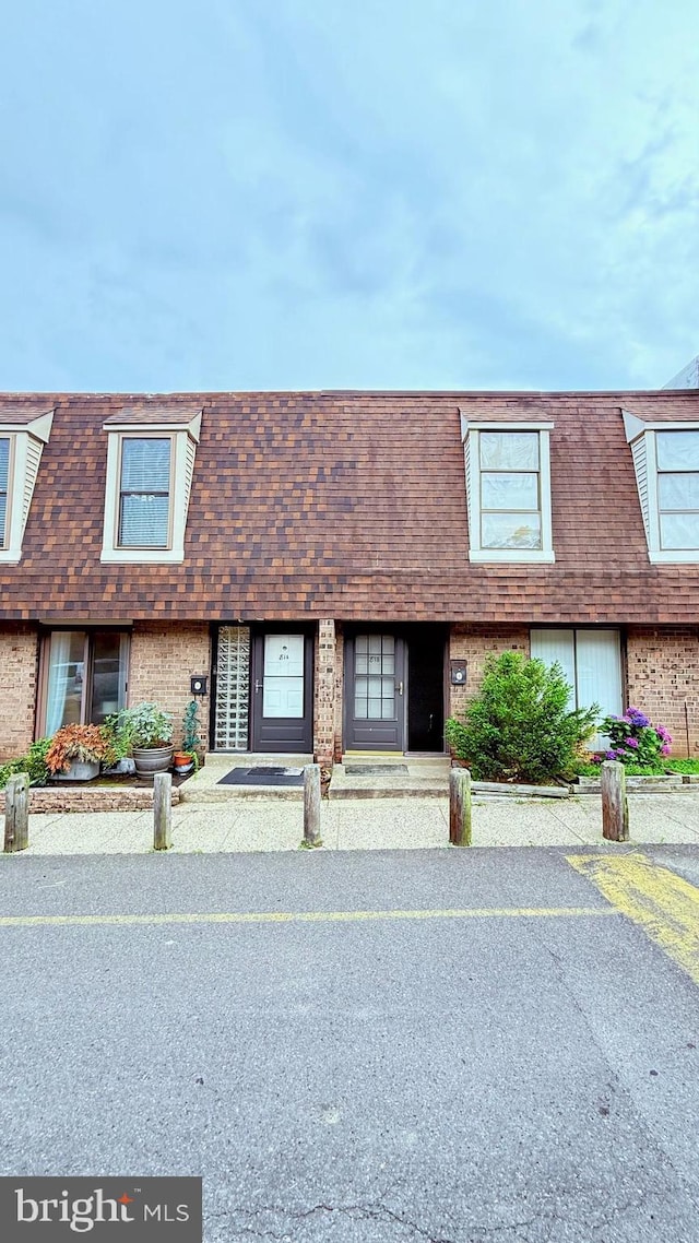 11881 Academy Rd Unit I6, Philadelphia, PA 19154 - view of property featuring mansard roof, brick siding, and a shingled roof