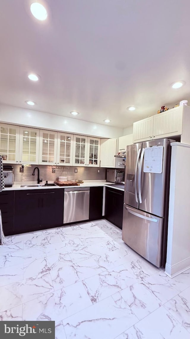 11881 Academy Rd Unit I6, Philadelphia, PA 19154 - kitchen with appliances with stainless steel finishes, recessed lighting, light marble finish floors, light countertops, and glass insert cabinets