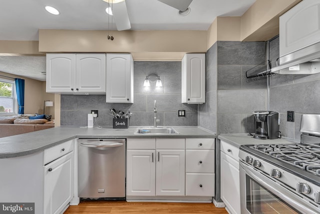 600 Central Ave, Runnemede, NJ 08078 - kitchen with stainless steel appliances, decorative backsplash, a peninsula, and white cabinets