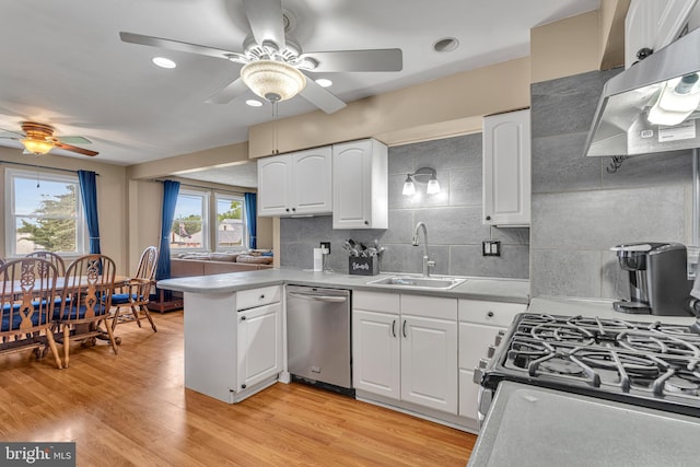 600 Central Ave, Runnemede, NJ 08078 - kitchen featuring appliances with stainless steel finishes, ceiling fan, exhaust hood, a peninsula, and white cabinets