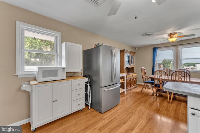 600 Central Ave, Runnemede, NJ 08078 - kitchen with freestanding refrigerator, white microwave, a ceiling fan, and light wood-style floors