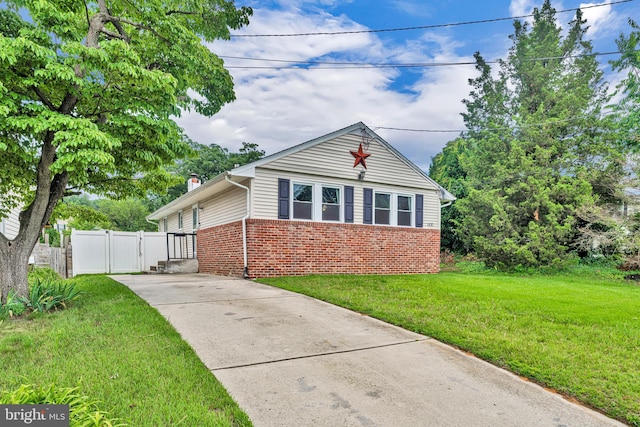 600 Central Ave, Runnemede, NJ 08078 - bungalow with brick siding, concrete driveway, a chimney, and a gate