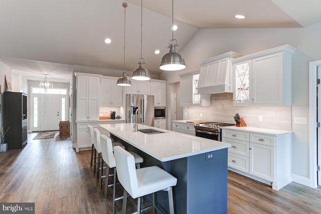 17 Beckleys Cor, Lebanon, PA 17042 - kitchen with appliances with stainless steel finishes, white cabinets, a breakfast bar, vaulted ceiling, and light countertops