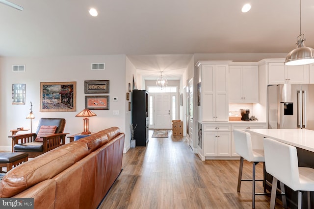 17 Beckleys Cor, Lebanon, PA 17042 - kitchen with high end refrigerator, light wood-style floors, white cabinets, recessed lighting, and open floor plan