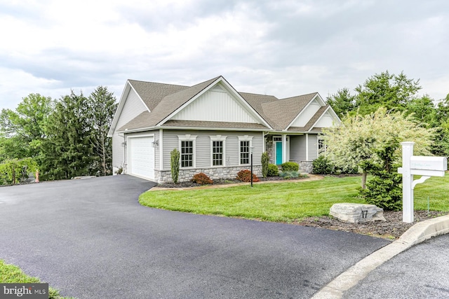 17 Beckleys Cor, Lebanon, PA 17042 - view of front of house with board and batten siding, stone siding, an attached garage, a front lawn, and asphalt driveway