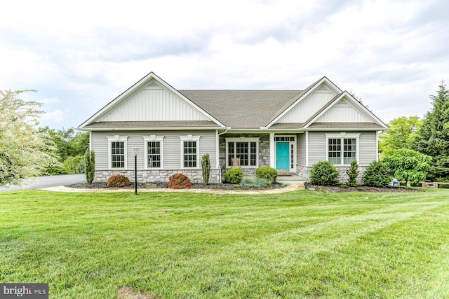 17 Beckleys Cor, Lebanon, PA 17042 - view of front facade featuring board and batten siding, stone siding, a front yard, and a shingled roof