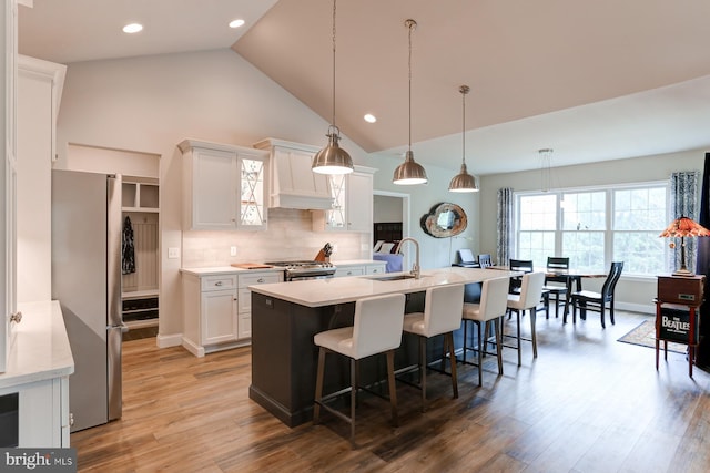 17 Beckleys Cor, Lebanon, PA 17042 - kitchen featuring appliances with stainless steel finishes, light countertops, a kitchen bar, white cabinets, and light wood-style flooring