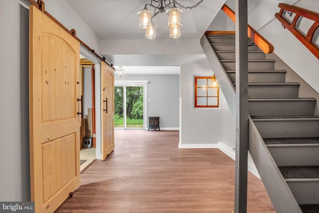 1773 Kings Arms Ct, New Cumberland, PA 17070 - entrance foyer with a barn door, stairs, wood finished floors, and a chandelier