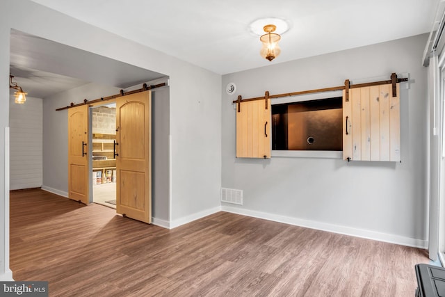 1773 Kings Arms Ct, New Cumberland, PA 17070 - unfurnished room featuring a barn door and wood finished floors