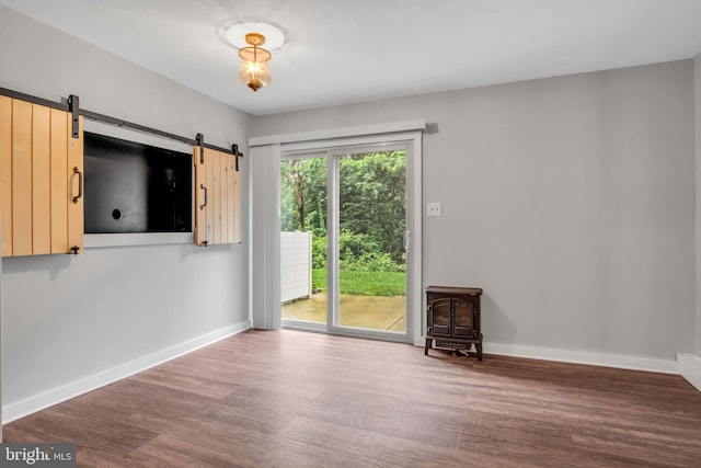 1773 Kings Arms Ct, New Cumberland, PA 17070 - spare room with wood finished floors, a wood stove, and a barn door